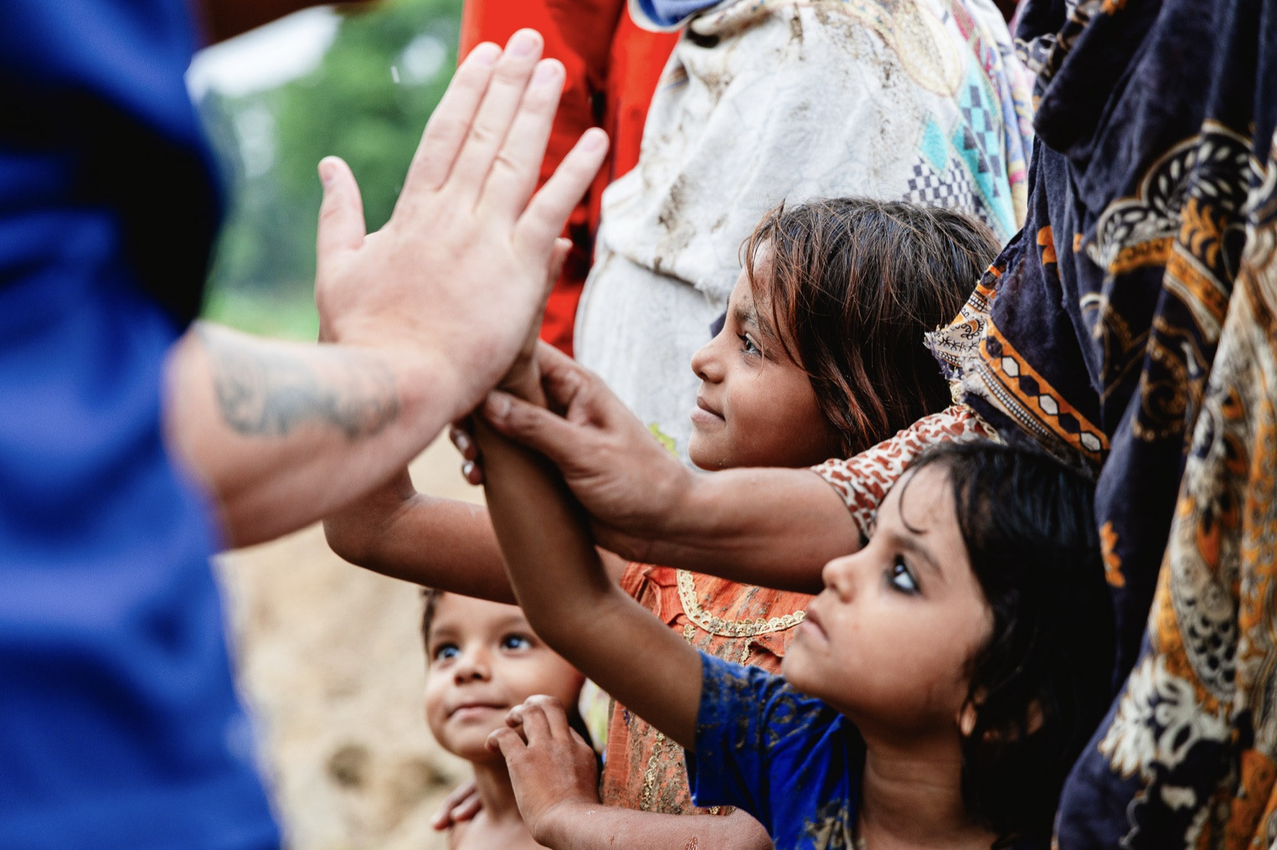 An Exodus51 team member high-fives laughing children