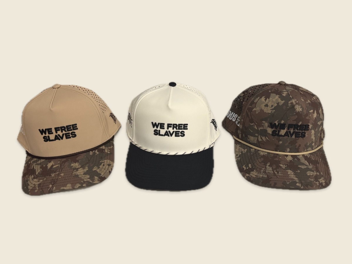 Three We Free Slaves caps in tan camo, white and black, and full camo