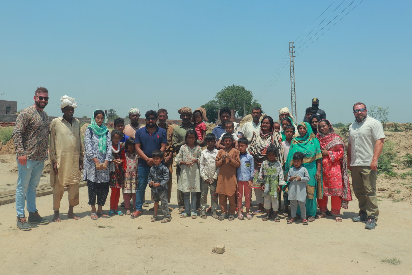 The Exodus51 team standing with a newly freed family at a brick kiln